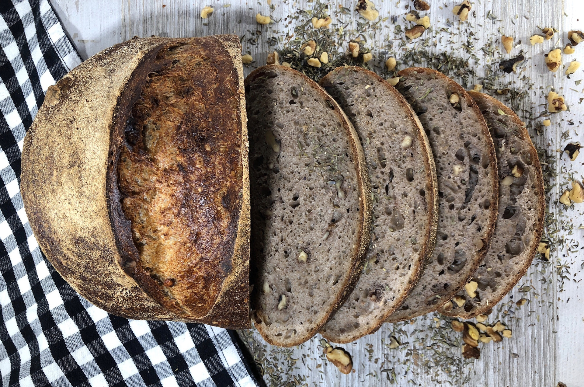 [FRENCH QUARTER IMAGE] – walnut and herb sourdough, sliced